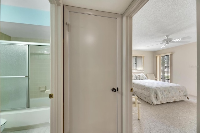 carpeted bedroom with a textured ceiling and ceiling fan