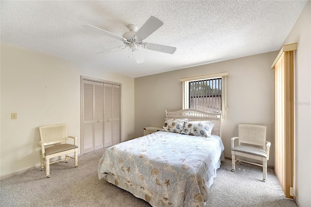 bedroom featuring ceiling fan, a textured ceiling, a closet, and carpet