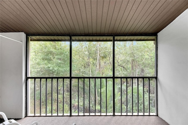 unfurnished sunroom featuring wood ceiling