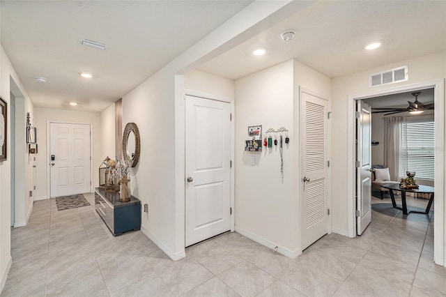 hallway with light tile patterned floors