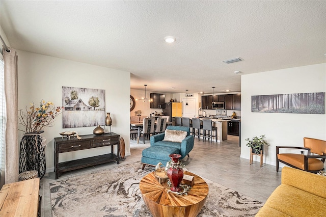 living room featuring a textured ceiling and light tile patterned flooring