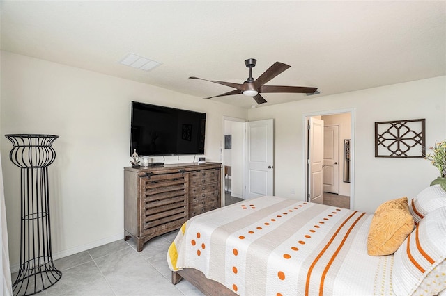 tiled bedroom featuring ceiling fan