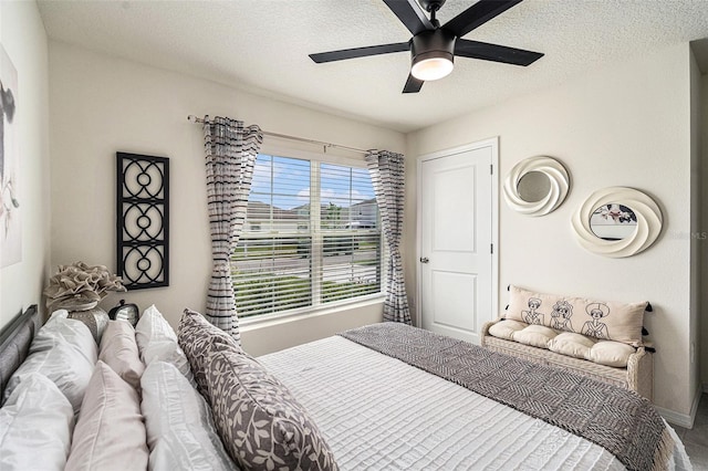 bedroom with a textured ceiling and ceiling fan