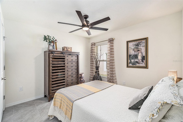 bedroom featuring ceiling fan and light tile patterned floors