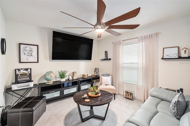 living room featuring ceiling fan and light tile patterned floors