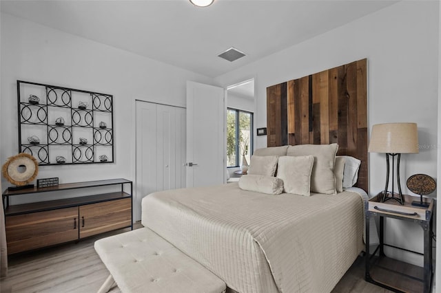 bedroom with wood-type flooring and a closet