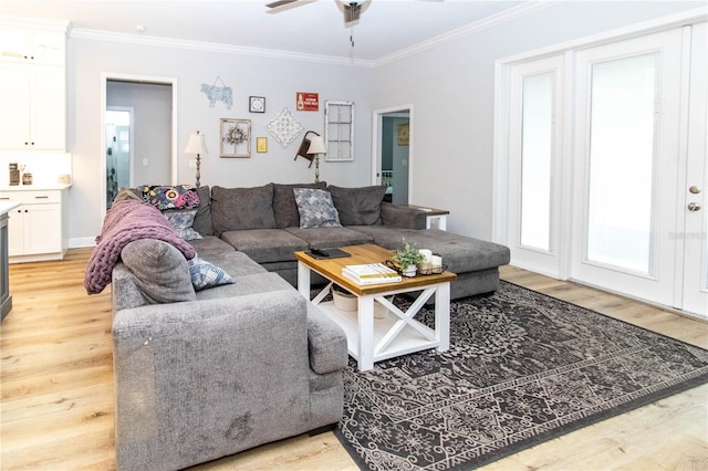 living room with crown molding, ceiling fan, and light hardwood / wood-style flooring