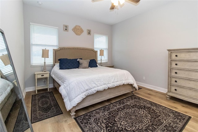 bedroom with hardwood / wood-style floors and ceiling fan