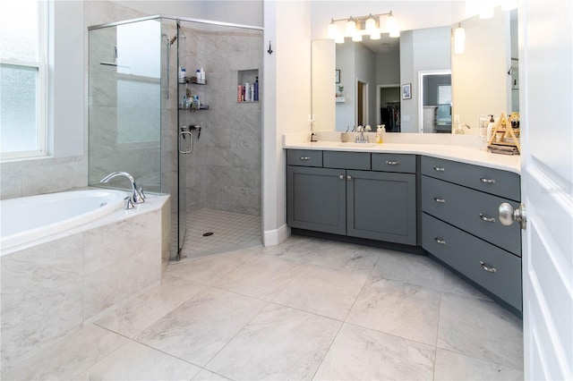 bathroom featuring vanity and separate shower and tub