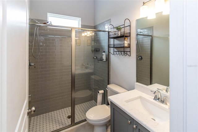 bathroom with vanity, toilet, and an enclosed shower