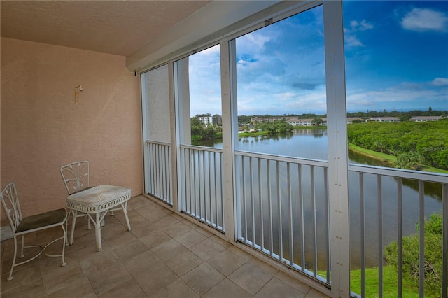 unfurnished sunroom with a water view