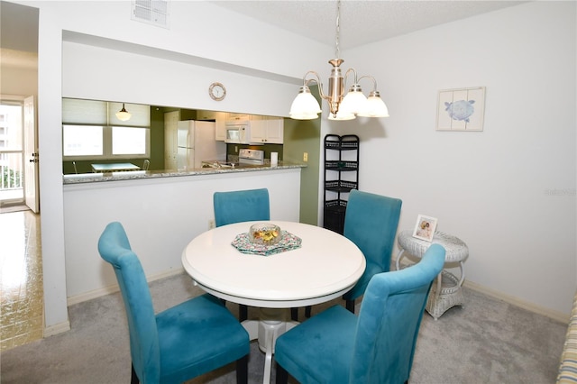 dining area featuring light carpet and a notable chandelier