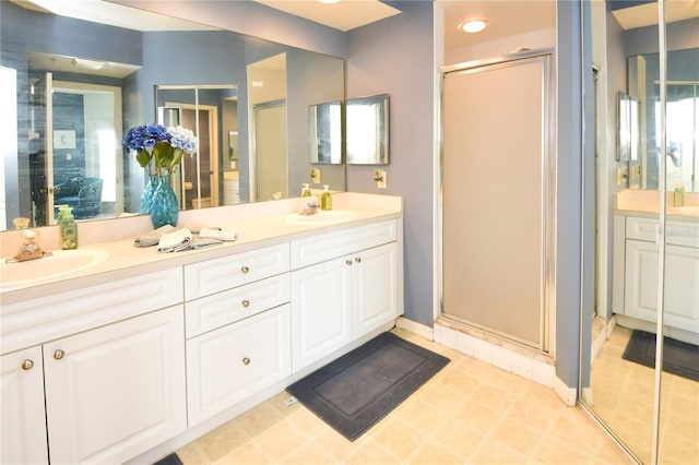 bathroom with walk in shower, vanity, and plenty of natural light