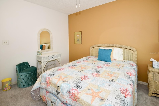 bedroom featuring carpet floors and a textured ceiling