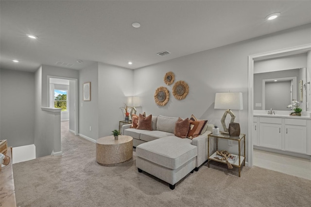 carpeted living room with sink