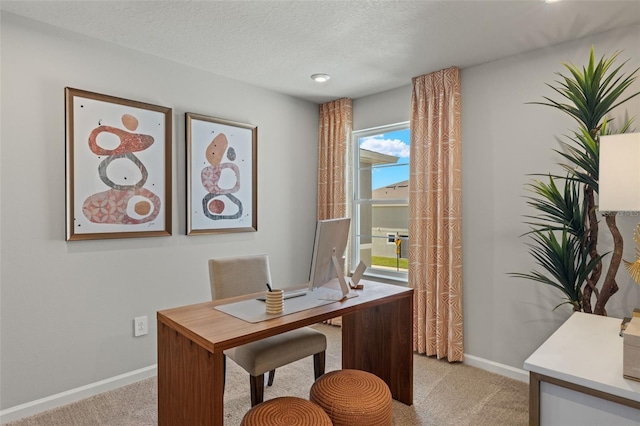 office area with light carpet and a textured ceiling