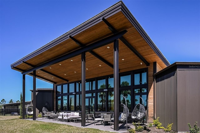 view of property's community with outdoor lounge area and a patio area