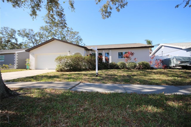 single story home with a garage and a front lawn