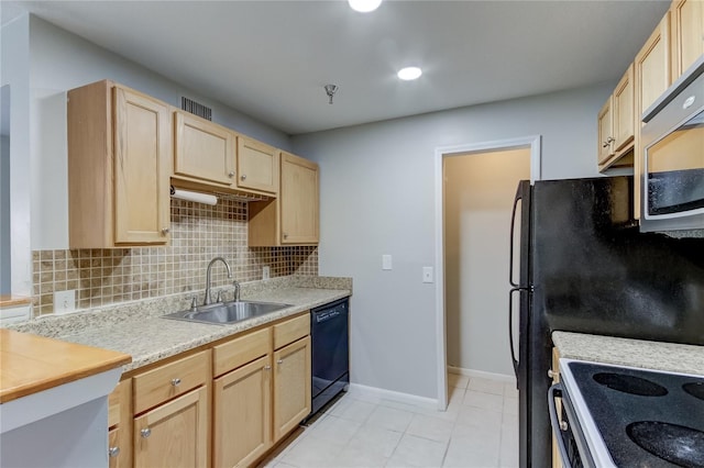 kitchen with light tile patterned floors, sink, tasteful backsplash, light brown cabinetry, and black dishwasher