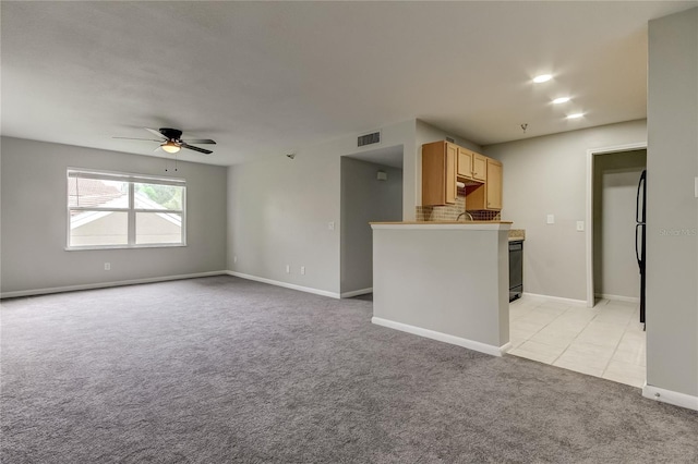 interior space with ceiling fan and light colored carpet