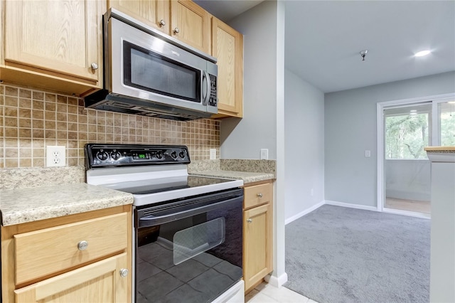 kitchen featuring light carpet, light brown cabinets, black electric range oven, and tasteful backsplash