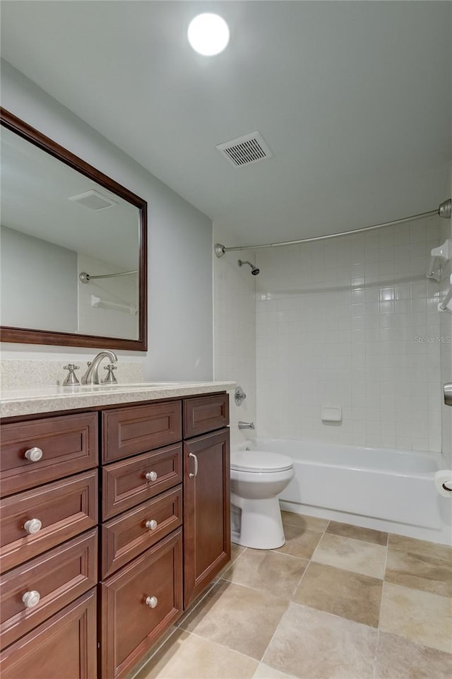 full bathroom with tiled shower / bath combo, vanity, toilet, and tile patterned floors