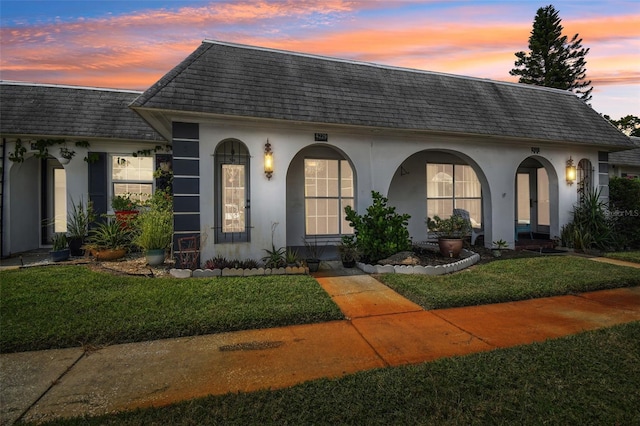 mediterranean / spanish home with a lawn