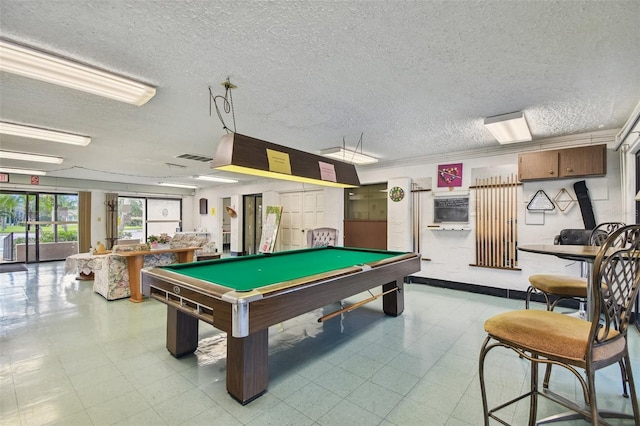 playroom with a textured ceiling, ornamental molding, and billiards