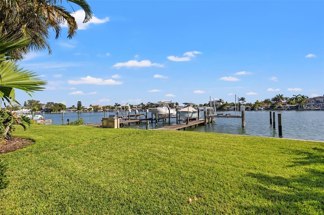 view of dock with a yard and a water view