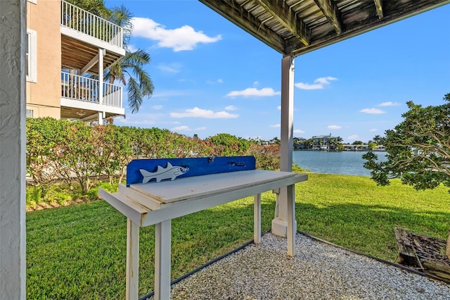 exterior space with a water view and a yard