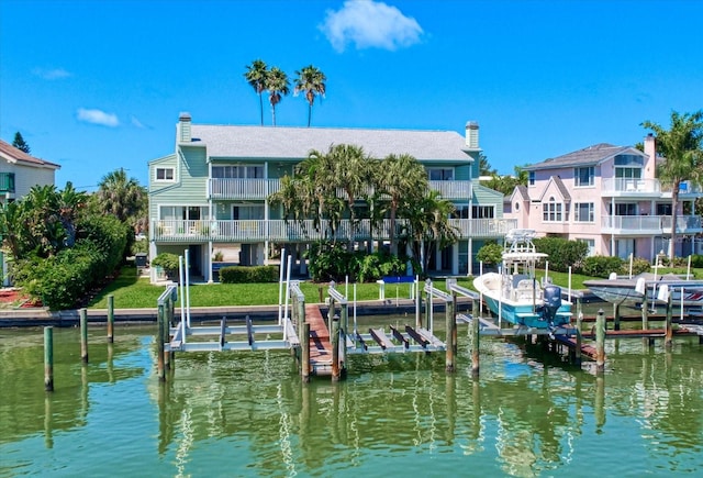 dock area with a balcony and a water view