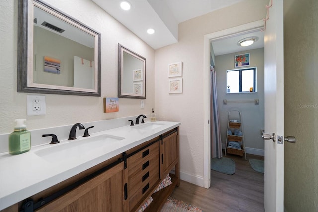 bathroom with wood-type flooring and vanity