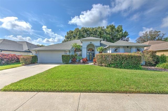 view of front facade with a garage and a front lawn