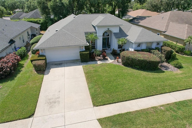 view of front facade with a garage and a front lawn