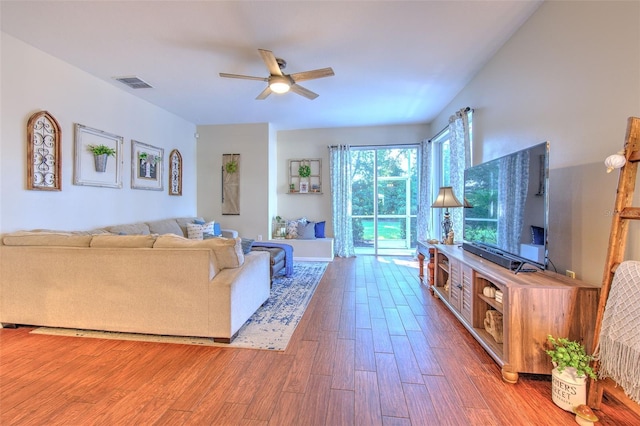 living room featuring ceiling fan and hardwood / wood-style flooring