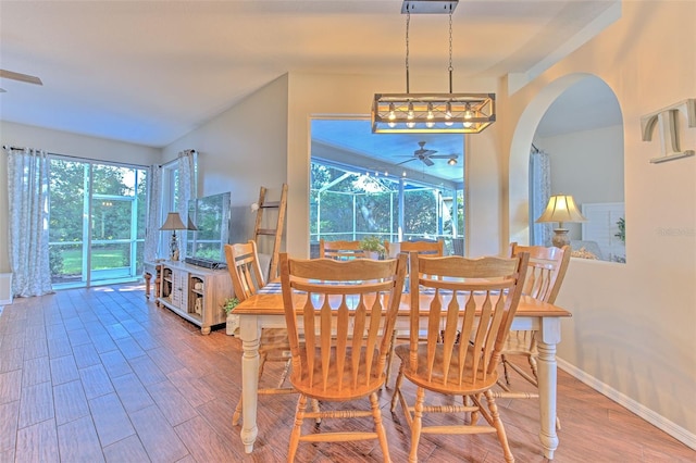 4923 Willow Ridge Ter, Valrico, FL 33596 - dining area featuring baseboards, a ceiling fan, arched walkways, and wood finished floors