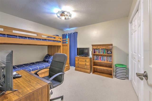 bedroom featuring a closet, carpet, and a textured ceiling