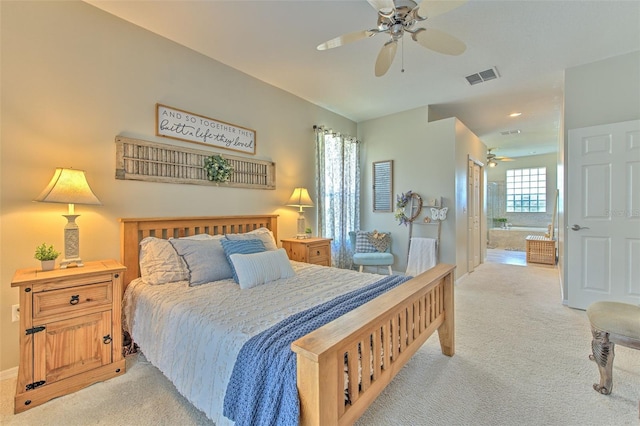 carpeted bedroom featuring ensuite bath, multiple windows, and ceiling fan