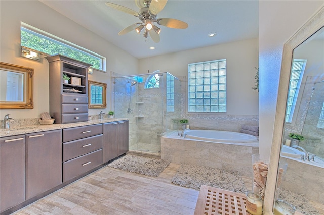 bathroom with independent shower and bath, vanity, hardwood / wood-style floors, and ceiling fan