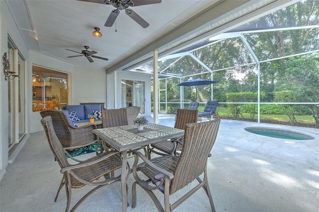 view of patio with glass enclosure, a pool, ceiling fan, and an outdoor hangout area