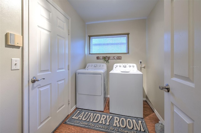 laundry room with dark hardwood / wood-style floors and independent washer and dryer