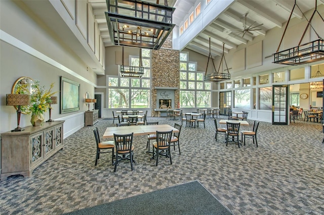 dining area with high vaulted ceiling, beam ceiling, carpet, and ceiling fan