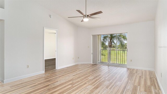 unfurnished room featuring light hardwood / wood-style flooring, ceiling fan, high vaulted ceiling, and a textured ceiling