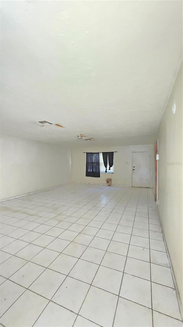 4906 E Idlewild Ave, Tampa, FL 33610 - unfurnished living room with light tile patterned flooring