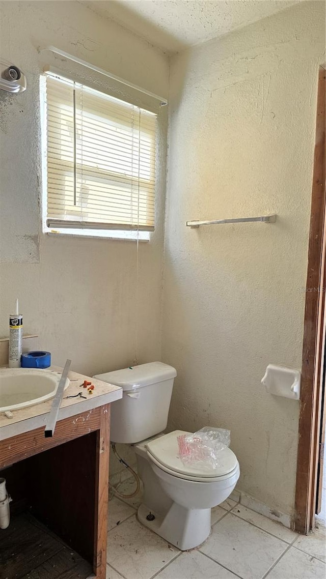 bathroom featuring vanity, toilet, and tile patterned floors