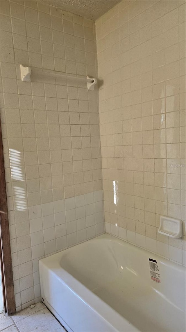 bathroom featuring shower / bathing tub combination and tile patterned flooring