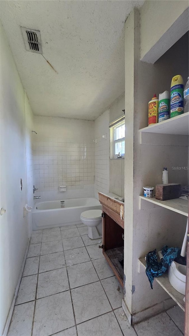 4906 E Idlewild Ave, Tampa, FL 33610 - bathroom with toilet, tile patterned floors, a textured ceiling,  shower combination, and vanity