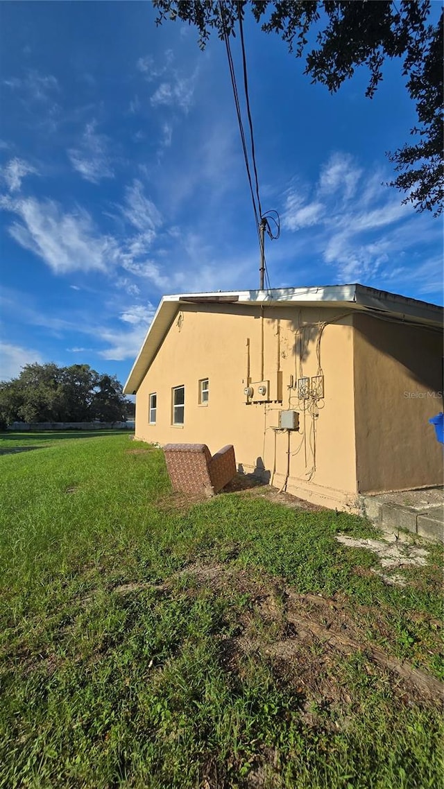 view of home's exterior with a yard