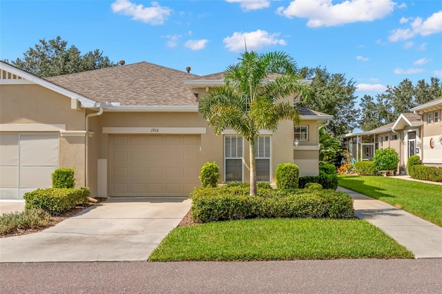 view of front of home with a garage and a front lawn