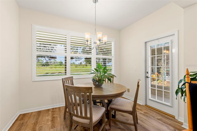 dining area featuring light hardwood / wood-style floors, a chandelier, and plenty of natural light